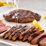 You should put olive oil on steak before grilling