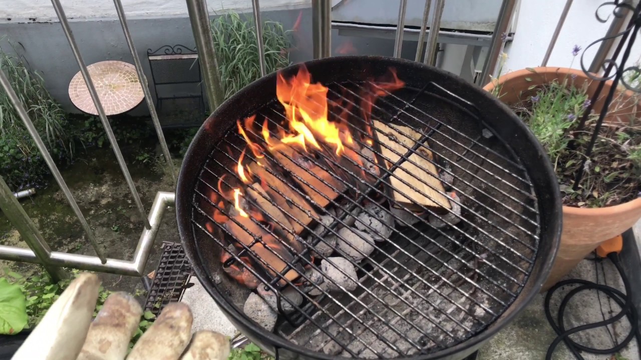 Using charcoal and wood to barbecue