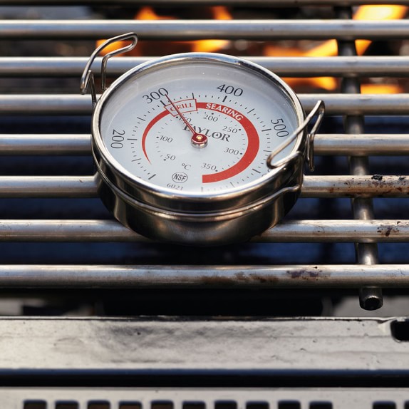 Using a grill surface thermometer to check the temp