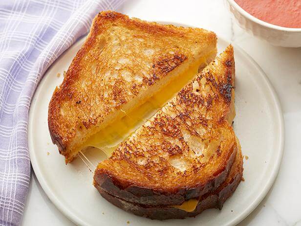 How does the taste of the two types of grilled cheese differ?